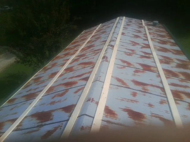 Rusted metal roof panels with new wood purlins before replacement — Storm Damage Roof Repair in Gold Canyon by Roofing Brothers