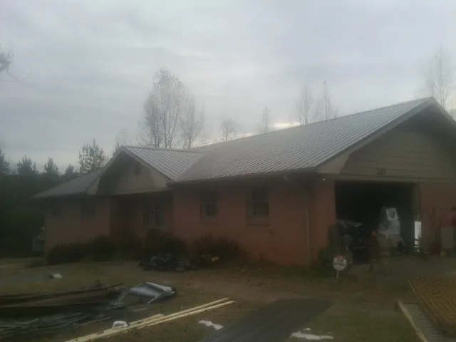 Gray metal roof on a stucco house with an attached garage in Gold Canyon